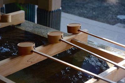 Close-up of traditional water basin with bamboo dippers