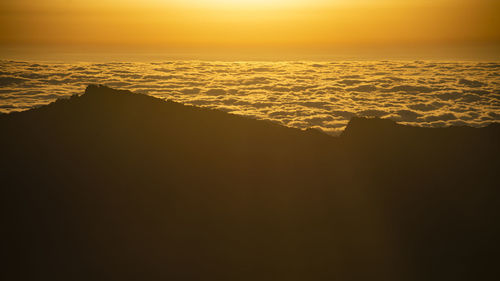 Scenic view of sea against orange sky