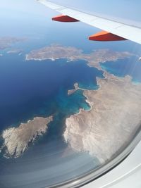 Aerial view of airplane wing over landscape