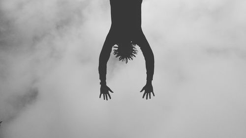 Directly below view of man against sky