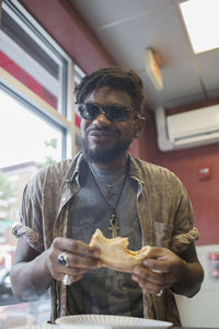 A young man eating pizza.
