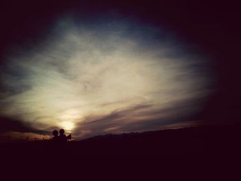 Silhouette landscape against sky at sunset