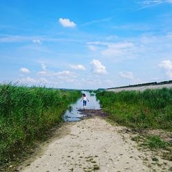 Full length of people walking on dirt road