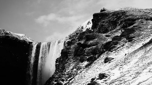 Scenic view of waterfall against sky