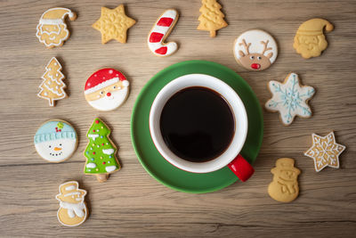 High angle view of coffee and cookies on table