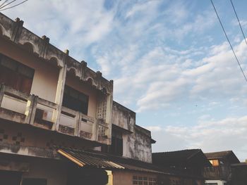 Low angle view of building against cloudy sky