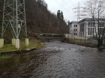 River flowing amidst buildings against sky