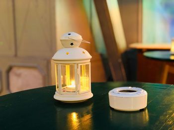 Close-up of illuminated lantern on table