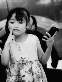 Girl looking away while using mobile phone
