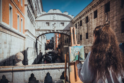 Rear view of people in city