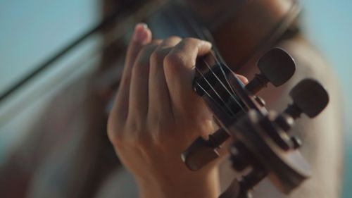 Close-up of hands playing guitar