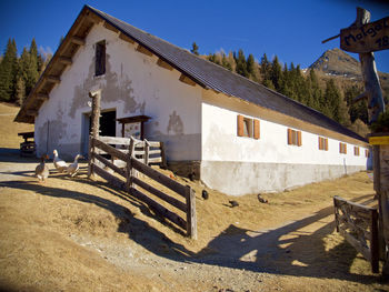 Built structure by building against clear blue sky