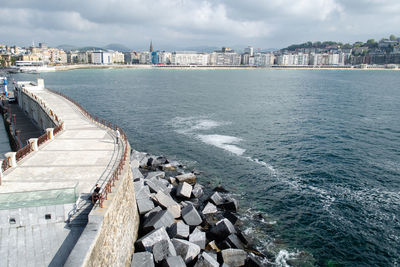 Panoramic view of sea and buildings against sky