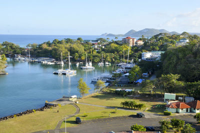 High angle view of buildings by lake against sky