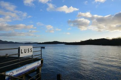 Scenic view of lake against cloudy sky