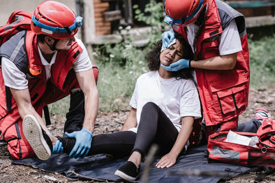 Paramedic workers rescuing woman during disaster