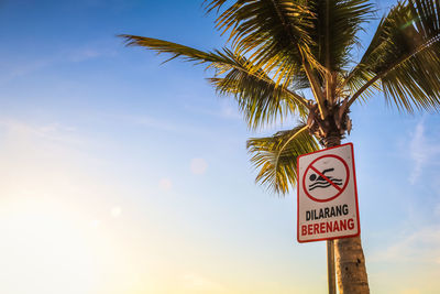 Low angle view of road sign against sky