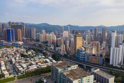 High angle view of modern buildings in city against sky