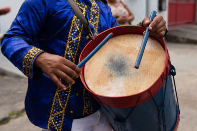 Members of a marujada, play percussion instruments during a parade at the chegancas meeting 