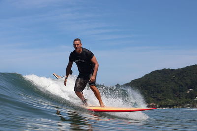 Full length of man in sea against sky