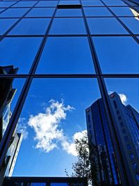 Low angle view of modern building against blue sky