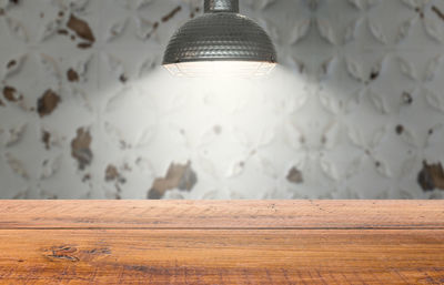 Close-up of illuminated light bulb on wall at home