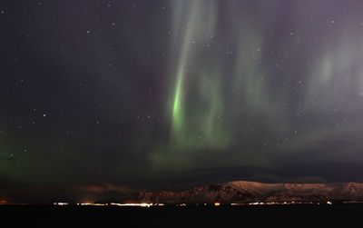 Scenic view of mountain range against sky at night