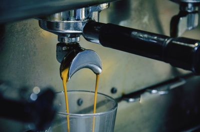 Close-up of coffee pouring in cup