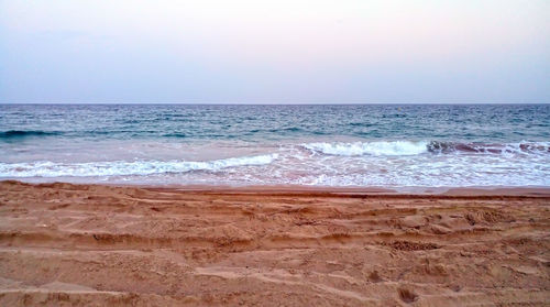 Scenic view of beach against clear sky