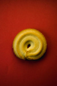 Close-up of lemon slice over red background