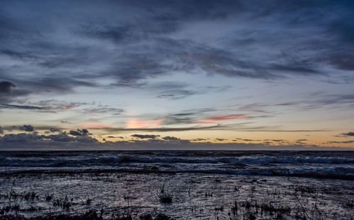 Scenic view of sea against sky at sunset