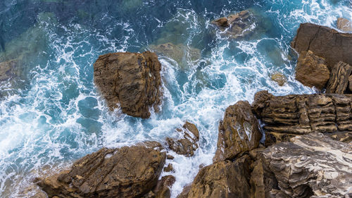 High angle view of rocks in sea