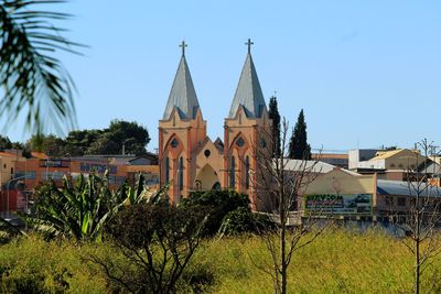 Panoramic view of trees and buildings against sky