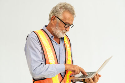 Man using mobile phone against white background