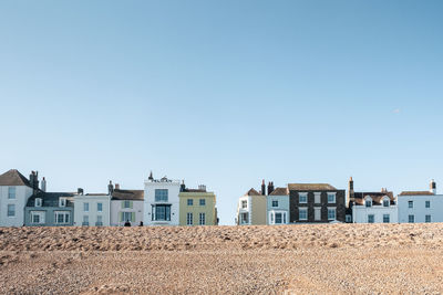 Residential buildings against clear blue sky