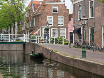 Canal by buildings in city