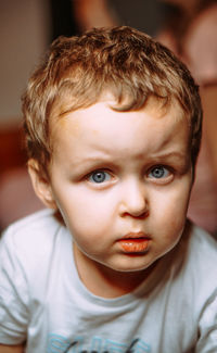 Close-up portrait of cute boy at home