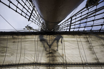 Two guys napping. low angle view of sail and tall ship mast against sky