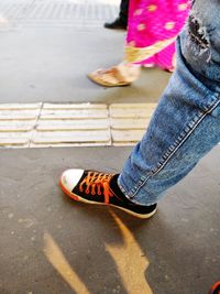 Low section of people walking on railroad station platform