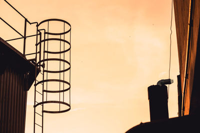 Low angle view of silhouette building against sky during sunset