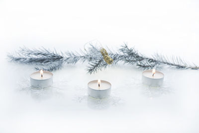 Close-up of snow on table against white background