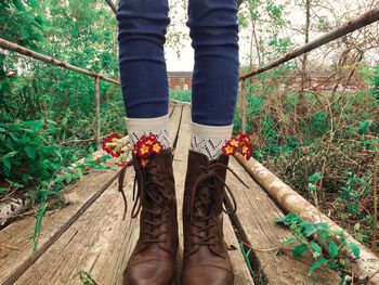 Low section of person standing on tree