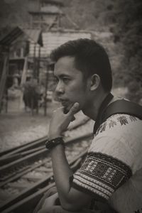 Portrait of young man smoking outdoors