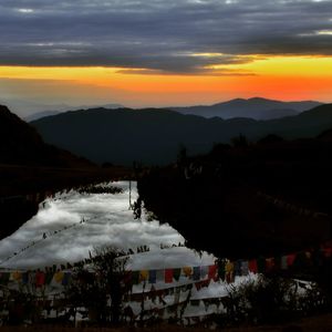 Scenic view of silhouette mountains against sky during sunset