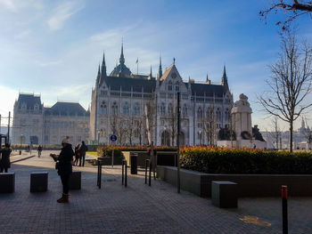 People in front of built structure against sky