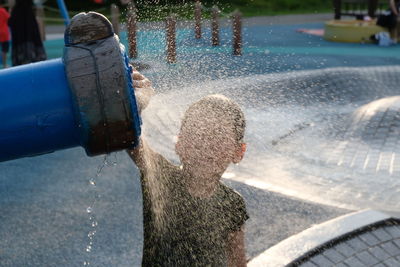 Rear view of boy on water