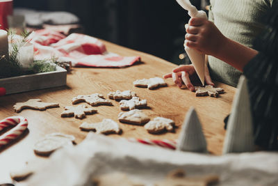Christmas, new year food preparation. gingerbread cooking, decorating cookies with icing, mastic