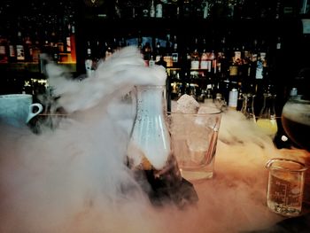 Cocktail with smoke on bar counter