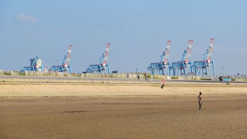 Man on beach against clear sky