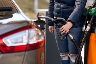 Low section of woman holding car